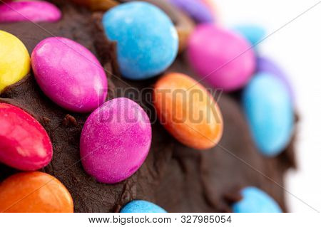 Kids Celebration Cake. Close Up Detail Of Colorful Chocolate Beans On Chocolate Frosting That Is Sli
