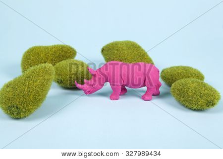 Moss Rocks And Pink Pop Plastic Rhinoceros