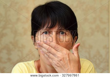 Middle Aged Woman. The Emotions Of Fright, Fear, Panic. She Covered Her Mouth With Her Hand