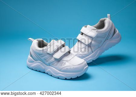 Two White Boys  Child Shoes With Velcro Fasteners For The Convenience Of Childrens Shoes, Isolated O