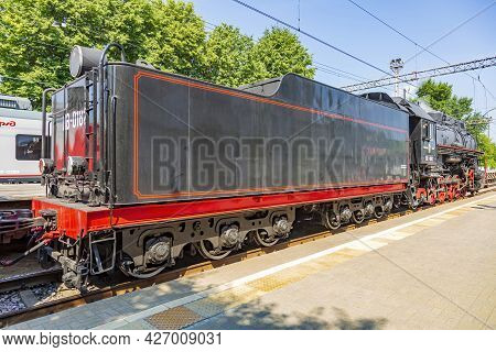 Black Retro Steam Locomotive At The Railway Station On A Sunny Day