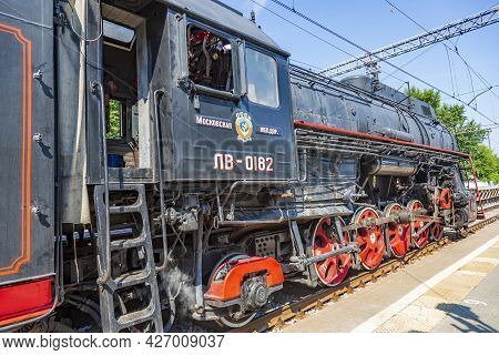 Black Retro Steam Locomotive At The Railway Station On A Sunny Day