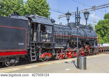 Black Retro Steam Locomotive At The Railway Station On A Sunny Day