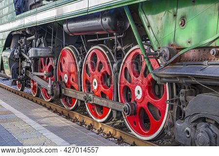 Green Retro Steam Locomotive At The Railway Station On A Sunny Day