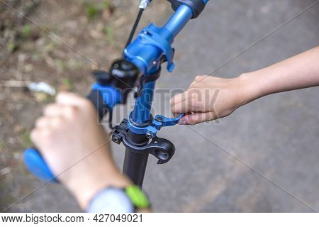 The Wheel Of A Scooter. Adjusting The Position Of The Scooter Steering Wheel. The Guy Adjusts The He