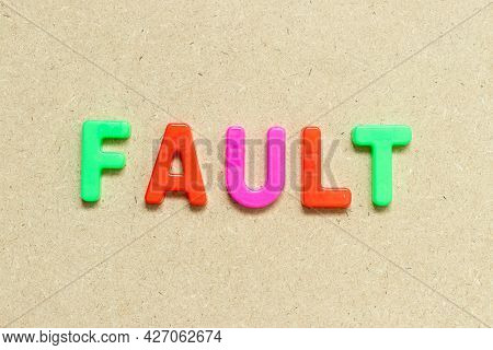 Color Alphabet Letter With Word Fault On Wood Background
