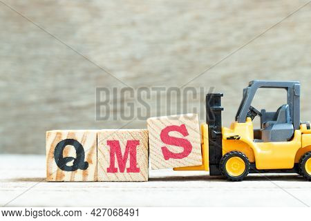 Toy Forklift Hold Letter Block S To Complete Word Qms (abbreviation Of Quality Management System) On