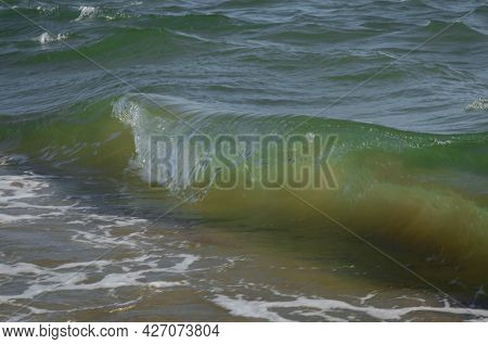 Colored Sea Waves With Splashes And White Breakers In Circeo Park, Sabaudia, Italy