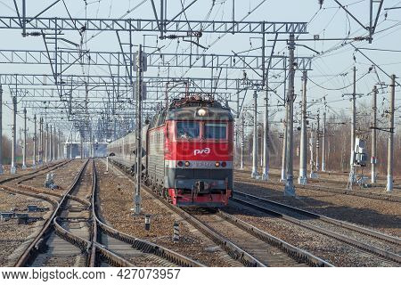 Leningrad Region, Russia - April 09, 2018: Passenger Train With Czechoslovak Electric Locomotive Chs