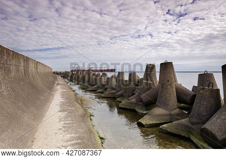Dolos And Lng Tanker - Ship Against Background Of Concrete Protection Of The Seaport And Sea Coast