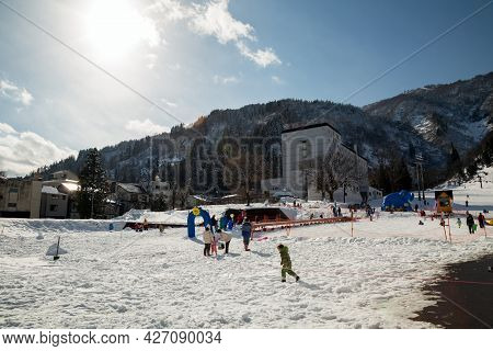 Yuzawa Japan 10 Jan 2016, Many Tourirt Playing Ski Snowboard On White Snow Mountain With Forest And 
