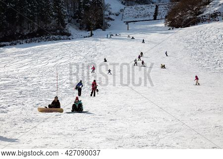 Yuzawa Japan 10 Jan 2016, Many Tourirt Playing Ski Snowboard On White Snow Mountain With Forest And 