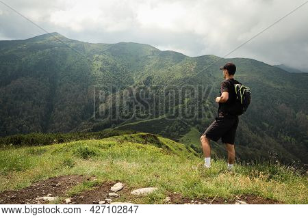 Athlete In A Black T-shirt Poses On Top Of The Mala Fatra Mountain. Climbing Mount Hromova. A Hiker 