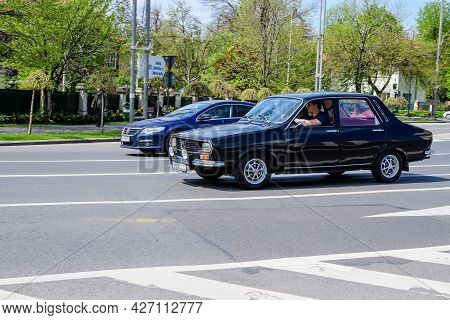 Bucharest, Romania, 24 April 2021 Old Retro Black Romanian Dacia 1300 Classic Car In Traffic In A St