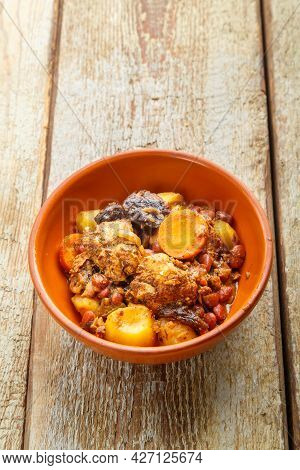 Jewish Dish Chelnt With Meat On A Wooden Table In A Plate. Vertical Photo