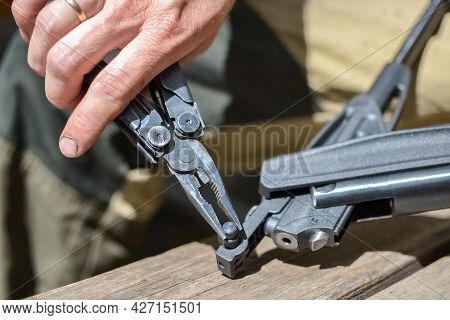 Hobbies and outdoor recreation. A man wipes an air rifle with a rag and prepares it for shooting.