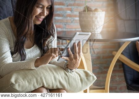 Asian Woman Using Phone And Touch Screen, Happy Thai Girl Sitting And Working Online Via Tablet At H