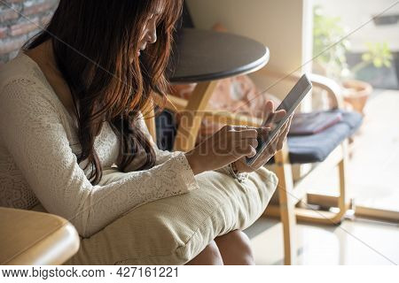 Asian Woman Using Phone And Touch Screen, Happy Thai Girl Sitting And Working Online Via Tablet At H