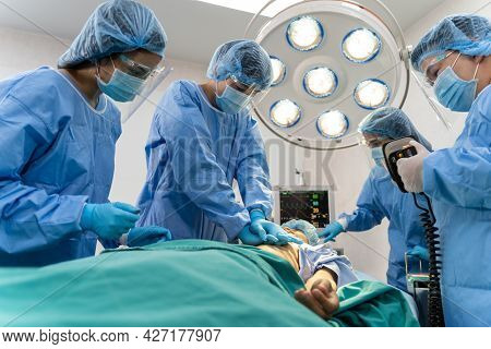 Medical Team In Surgical Gown Help Patient To Making Cpr Cardio Pulmonary Resuscitation In The Opera