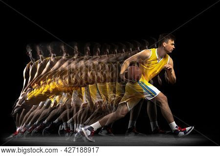Power And Speed. One Young Basketball Player Training With Ball Isolated On Dark Background With Str