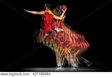 Power And Speed. One Young Basketball Player Training With Ball Isolated On Dark Background With Str