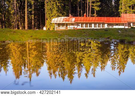 Bansko, Bulgaria Shiligarnika Autumn Ski Resort View With Mountains And House Reflection In Puddle W