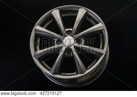 The New Alloy Wheel Is Gray On A Black Background. Auto Parts And Tuning