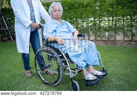 Doctor Help And Care Asian Senior Or Elderly Old Lady Woman Patient Sitting On Wheelchair At Park In
