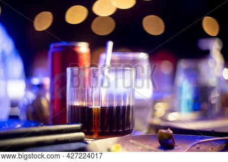 Shot Of Whiskey With Soda Fizzing Bubbling In An Elegant Glass With Out Of Focus Food Items All Arou