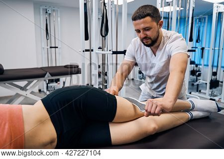 Physiotherapist Massaging Young Woman With Tool. Masseur Treats Sport Injury With Iastm Treatment