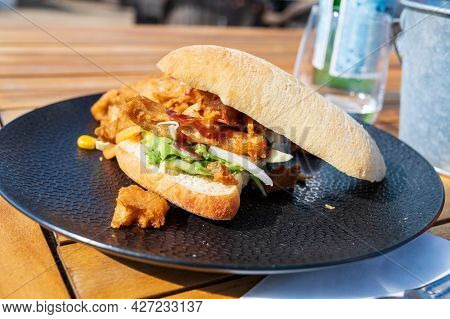 Italian Ciabata Bread Served With Fresh Salade And Vegan Fried Chicken In Pieces