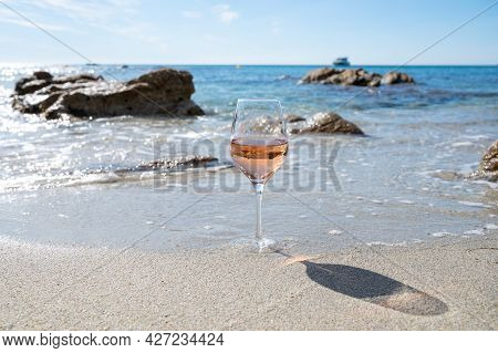 Summer Time In Provence, Glass Of Cold Rose Wine On Sandy Beach And Blue Sea Near Saint-tropez, Var