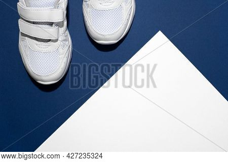 Photo Of A Pair Of White Childrens Sports Sneakers Made Of Leather And Sewn With Fabric With A Velcr
