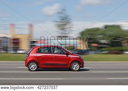 A Small Red Car. Renault Twingo Is Driving On The Road. Motion Blur. Riga, Latvia - 28 Jun 2021.