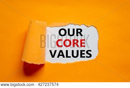 Our Core Values Symbol. Words 'our Core Values' Appearing Behind Torn Orange Paper. Beautiful Orange