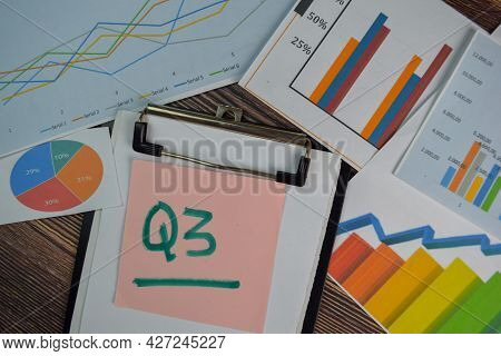 Q3 - 3rd Quarter Period Write On Sticky Notes Isolated On Wooden Table. Stock Market Concept