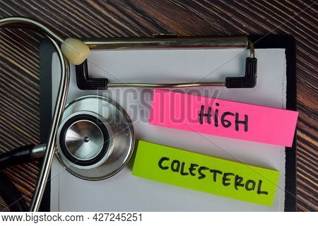 High Colesterol Write On Sticky Notes Isolated On Wooden Table. Medical Or Healthcare Concept