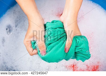 Closeup Young Asian Woman Use Hands Washing Color Clothes In Basin. Female Squeeze Wring Out Wet Fab