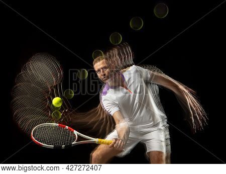 Portrait Of Young Man, Male Tennis Player In Motion And Action Isolated On Dark Background. Strobosc