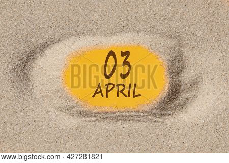 April 3. 3th Day Of The Month, Calendar Date. Hole In Sand. Yellow Background Is Visible Through Hol