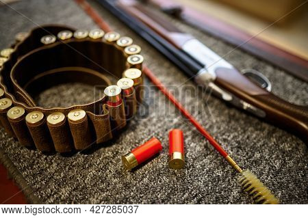 Hunting rifle, bandolier and ramrod in gun store