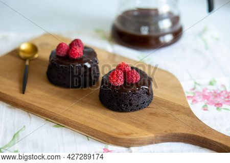 Healthy chocolate fondant.Chocolate fondant decorated with berries.Chocolate dessert with glaze with