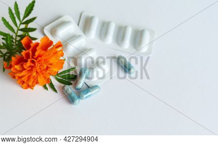 Dietary Supplement Capsules Of Marigold Flowers On White Background. Concept: Vision Improvement, Ey