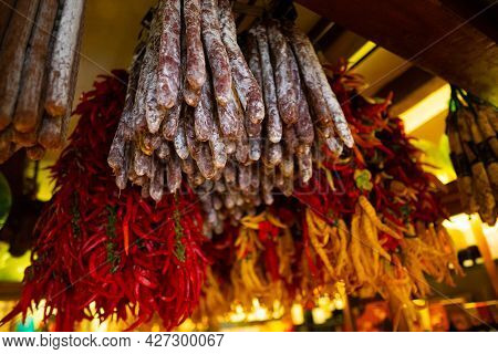 Suasages And Peppers Hanging Outside At Traditional Rural Market