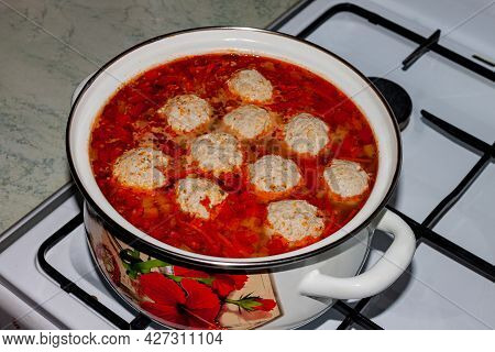 Food. Cooking. Soup Brideller With Tomatoes And Meat Meatballs In A Saucepan