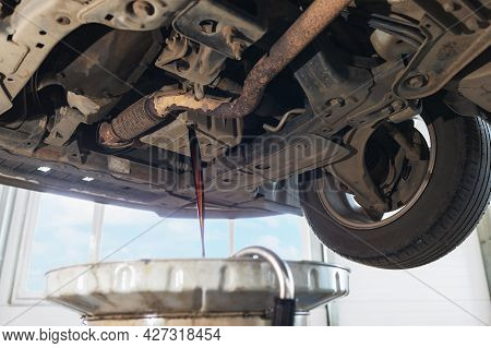 The Process Of Draining Used Engine Oil From The Crankcase Into The Sump