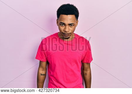 Young african american man wearing casua t shirt skeptic and nervous, frowning upset because of problem. negative person. 