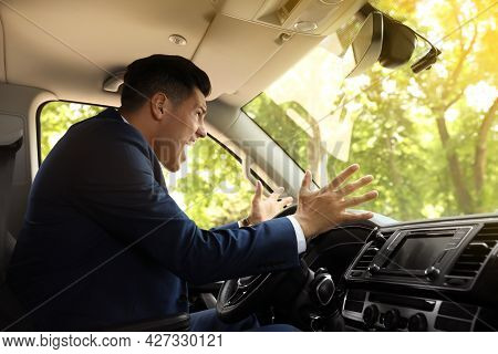 Emotional Man Yelling In Car. Aggressive Driving Behavior