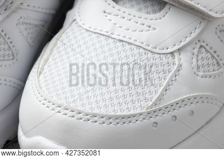 White Sneakers Close-up On Top. Macro Photo Of Childrens Leather Sports Sneakers Made Of Fabric With