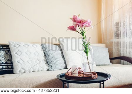 Interior And Home Decor. Fresh Pink Lily Flowers Put In Vase In Living Room By Couch. Bouquet Of Blo